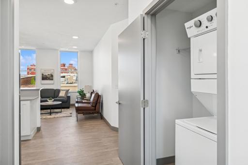 Separate laundry closet with stackable washer and dryer