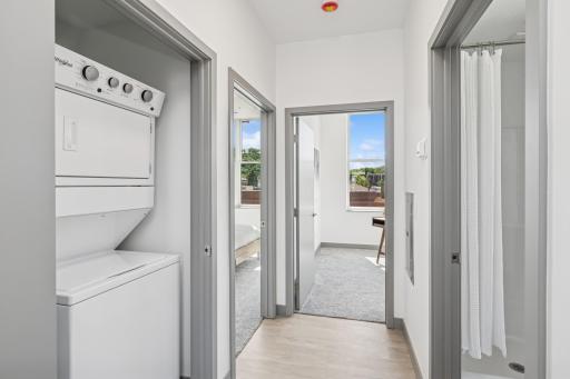 Separate laundry closet with stackable washer and dryer