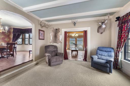 Light pooling through living, sunroom, and diningroom.