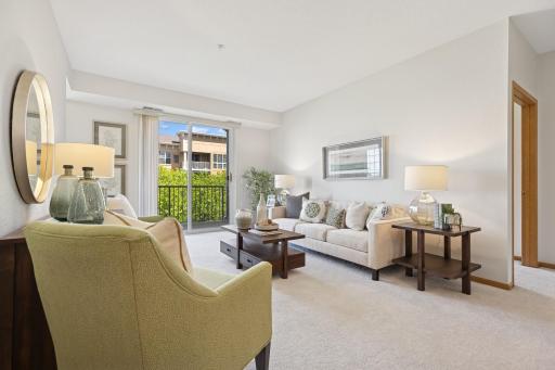Living room showcasing the newer carpet & neutral paint that's throughout the home.