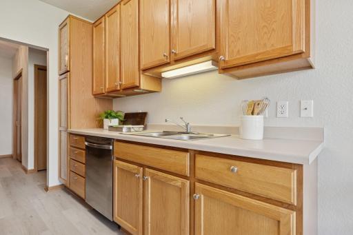 Cooking made easy in this efficient galley kitchen! Plenty of cupboards + pantry at the end offers abundant kitchen storage.