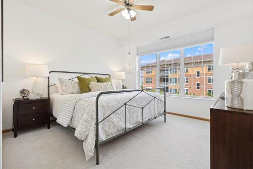 Primary Suite showcasing king sized bed + new, power operated room darkening shades.