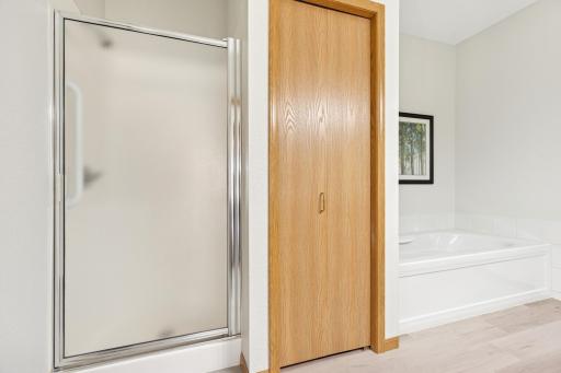Separate tub & shower + linen closet in primary bath.