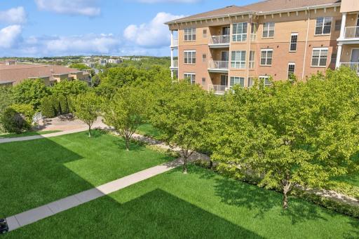 Views from this unit include the gorgeous courtyard & green space + the Mpls skyline off in the distance!
