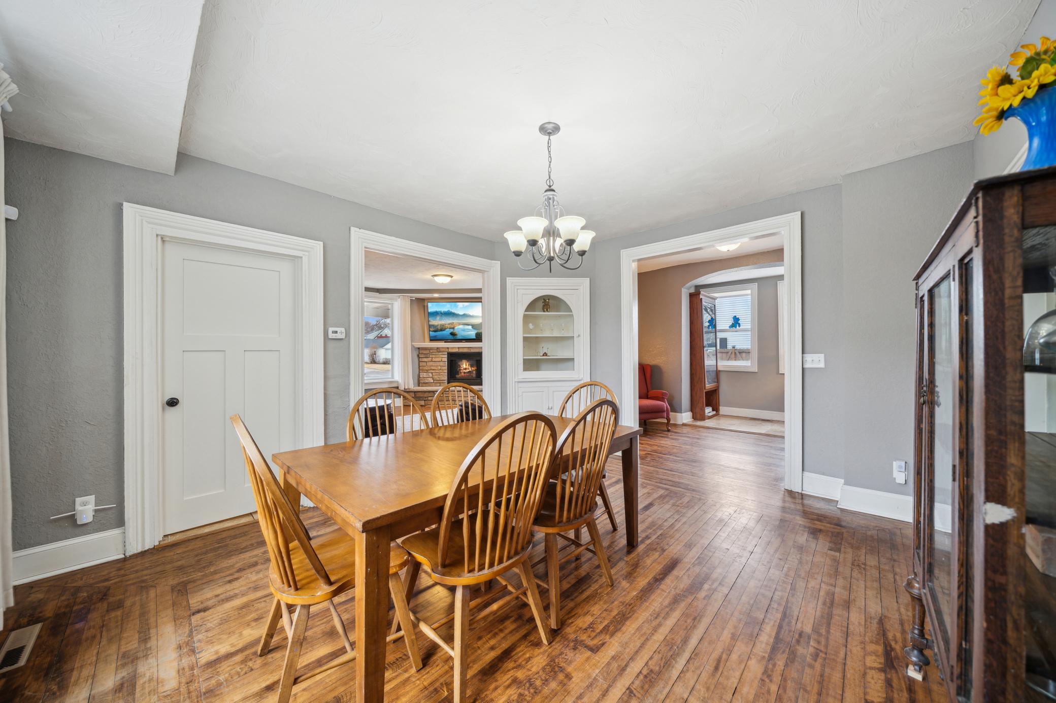 Even a built in curio cabinet to display your treasures! The dining room opens to the living room and a den/office area! Notice the beautiful wide baseboards!