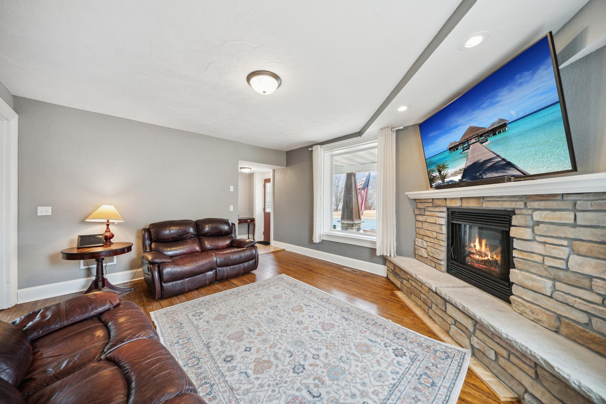 Plenty of space for your large TV above this stunning brick fireplace!
