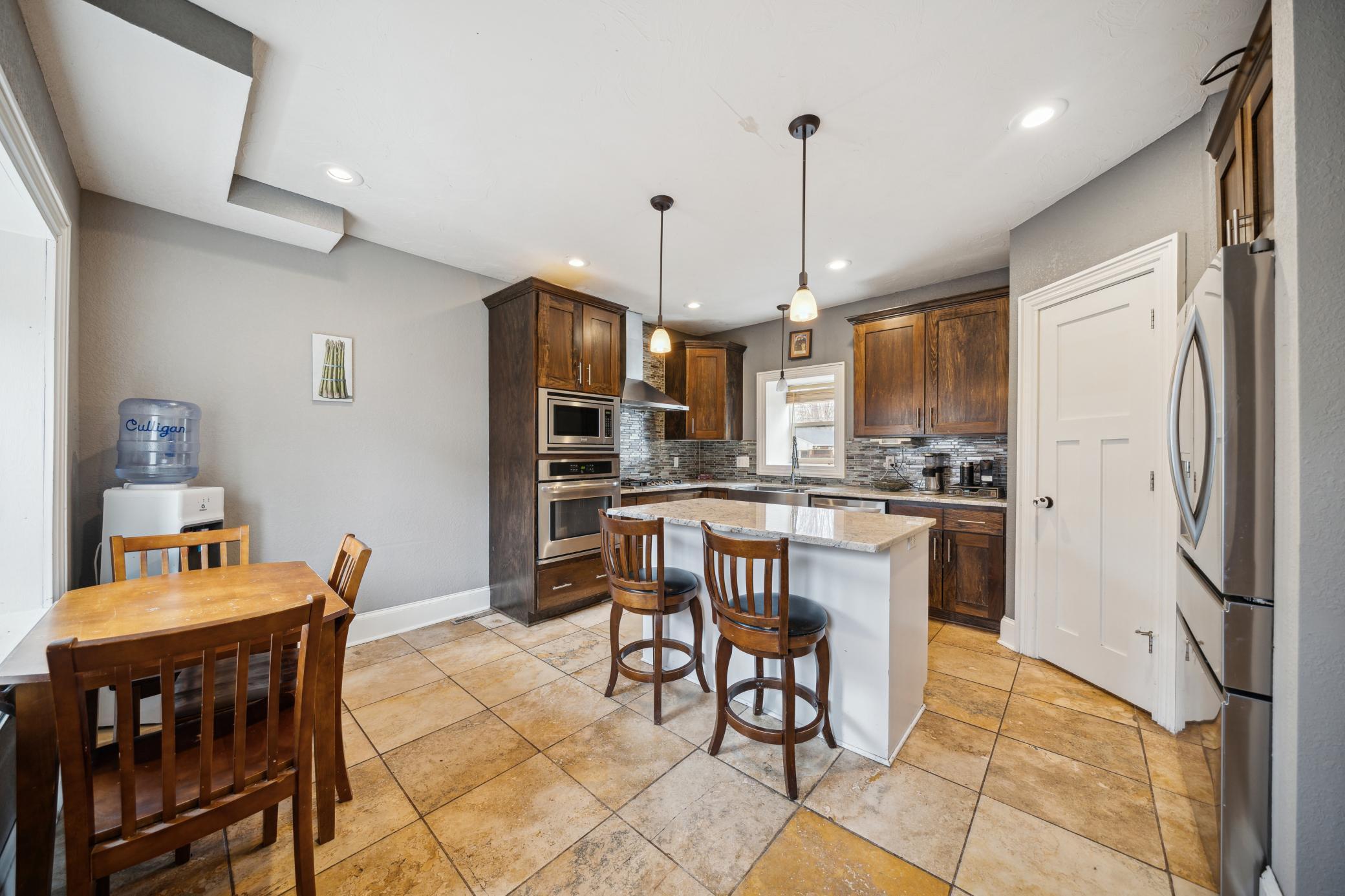 Totally renovated kitchen with SS appliances, granite countertops, large center island and still plenty of space for a table!