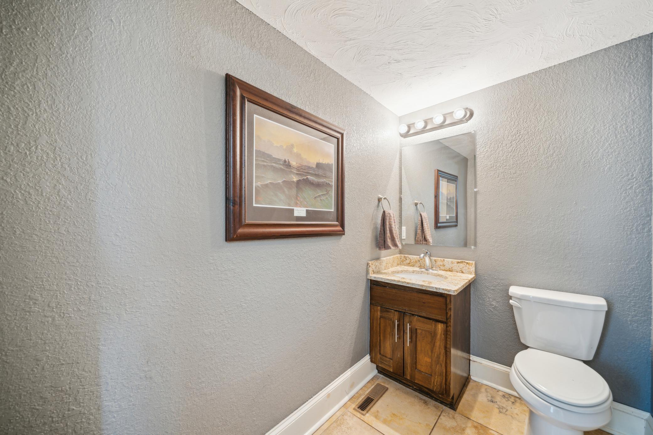 Stylish main floor powder room is just off the dining room area.