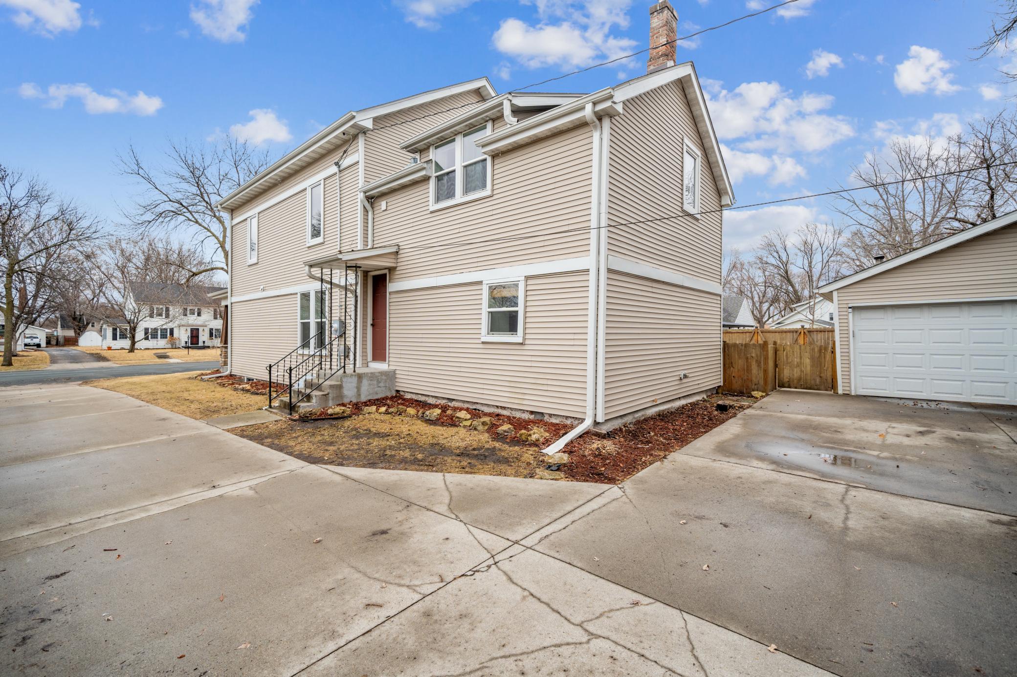 Cement drive way with extra outside parking spaces if needed---but there's a huge oversized 2 car garage with a new garage door!
