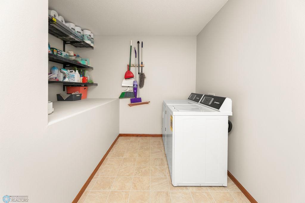 Laundry room on the upper level offers convenience and storage