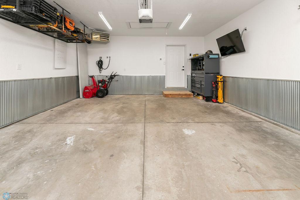 Finished, attached 2-car garage with storage and included heater
