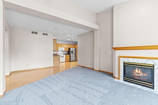 Vaulted living room highlighted with warm cozy fireplace and brand new carpets