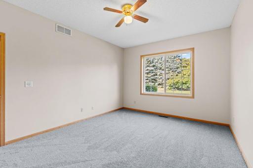 Primary bedroom with windows overlooking spacious grounds