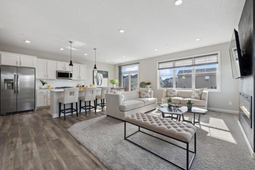 (Photo of decorated model, actual home's finishes will vary) The open floorplan promotes effortless flow between the kitchen, dining and great room.