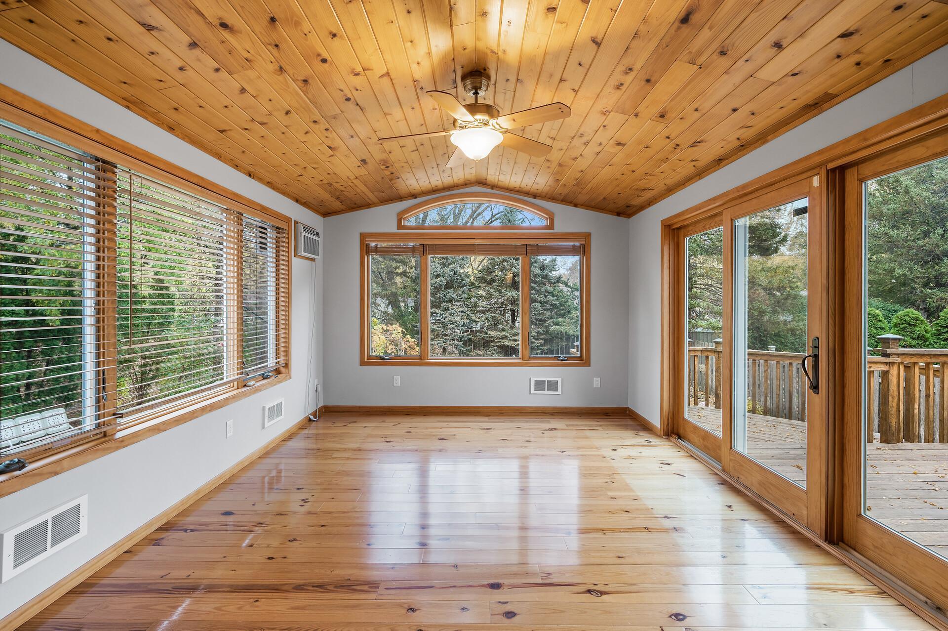 The four-season porch offers panoramic views of the backyard, creating a serene backdrop for relaxation and entertaining.