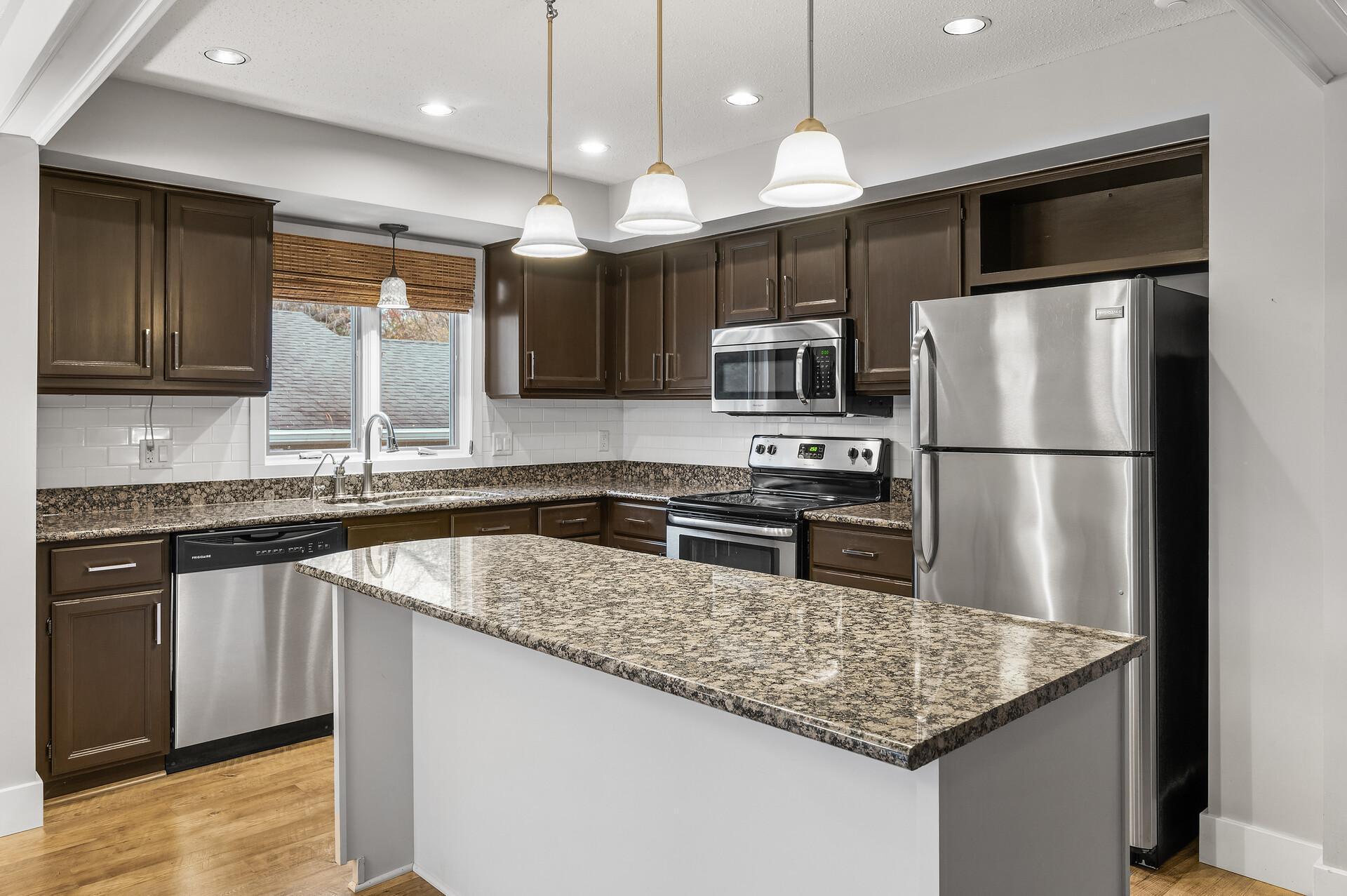 Window over the kitchen sink looks out to deck and backyard.