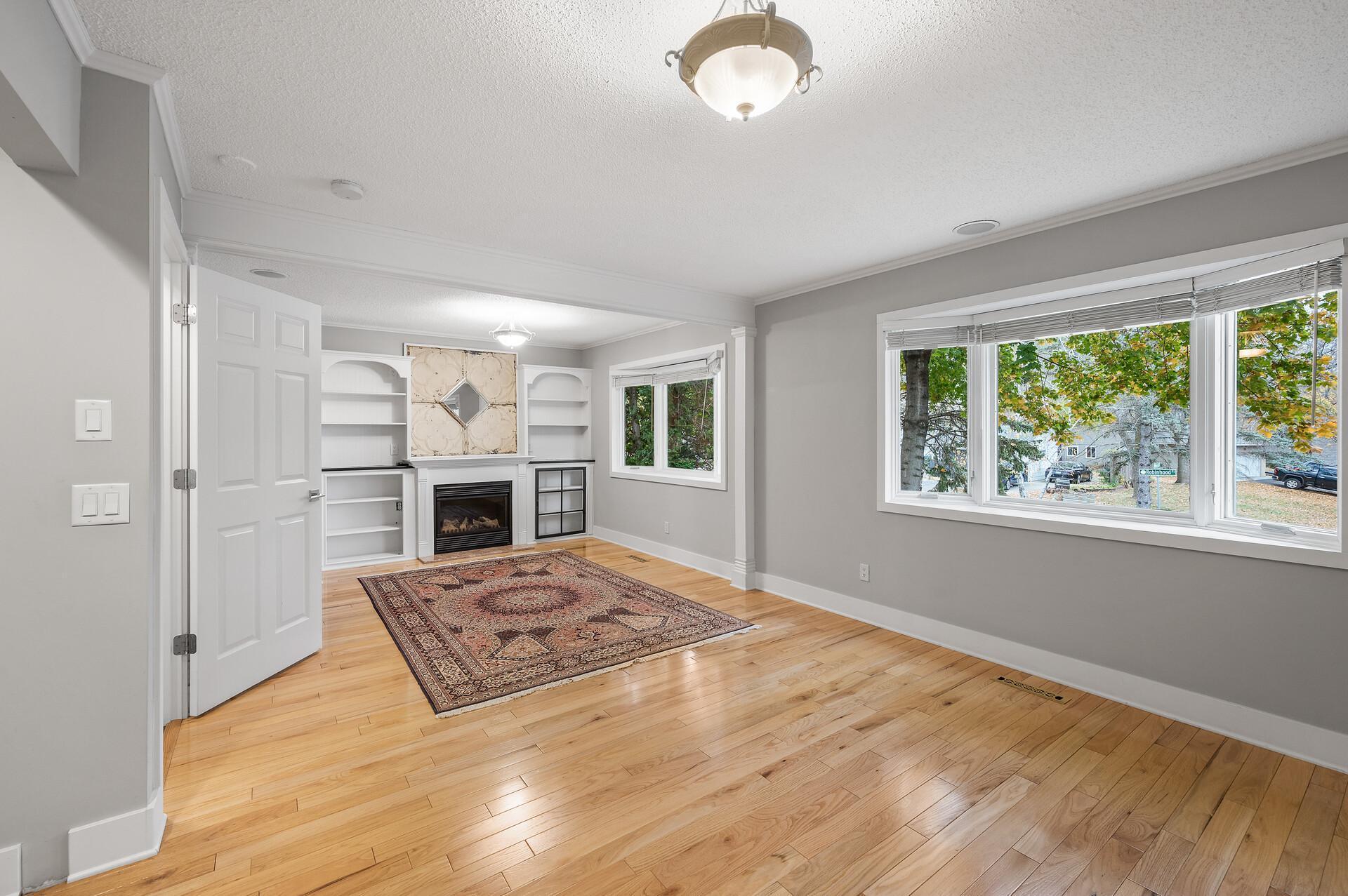 Extra large primary suite with hardwood floors, gas burning fireplace, and built in cabinets.