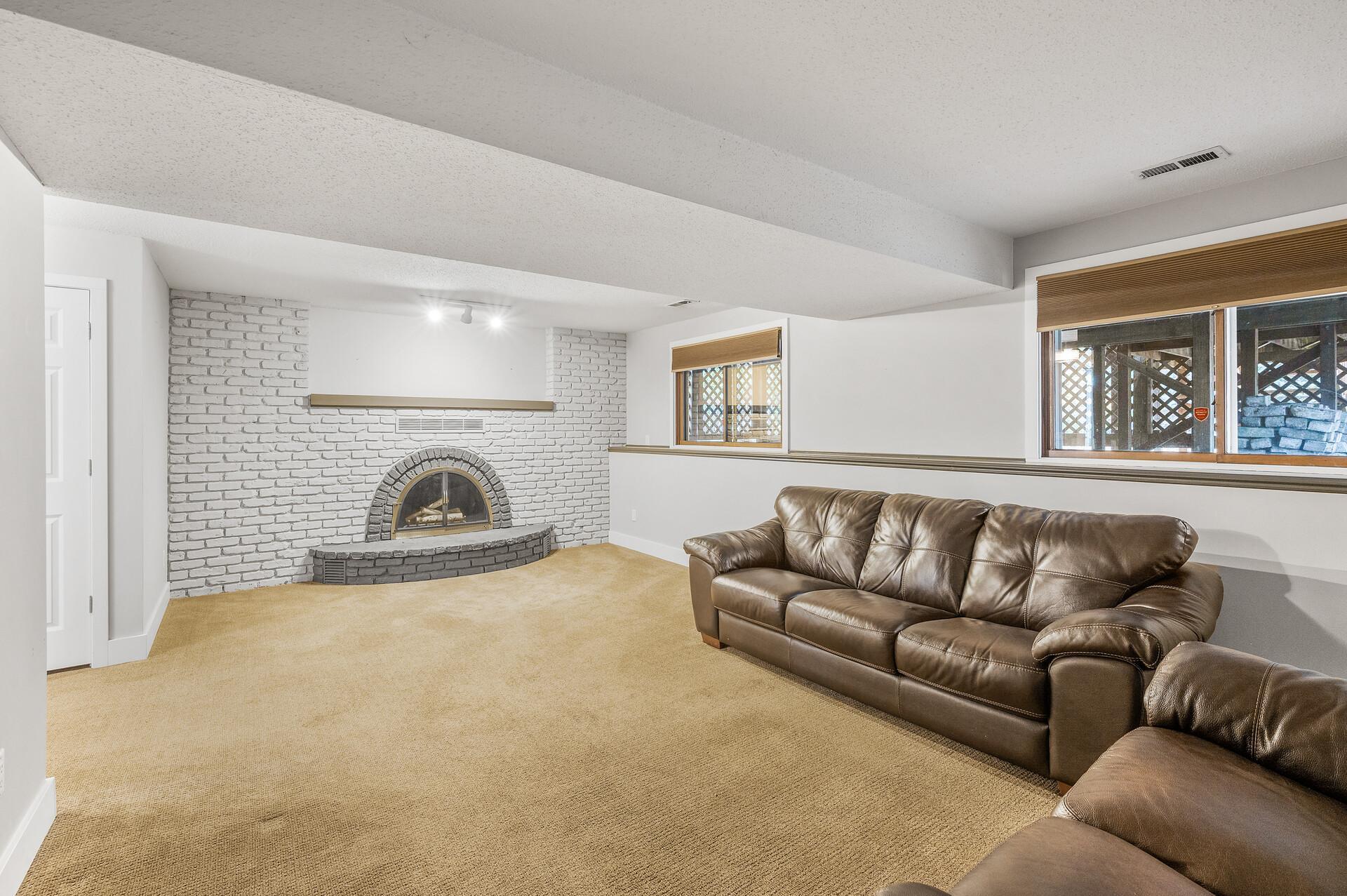 Classic brick surround fireplace located in the lower level family room.