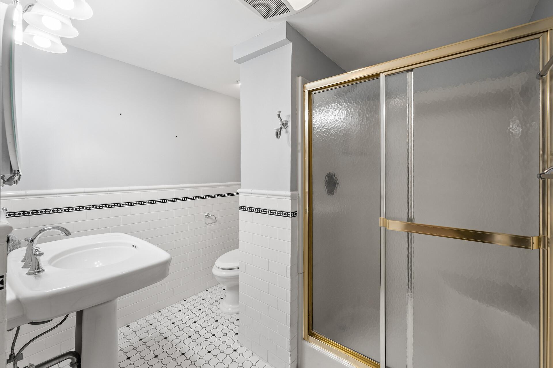 Lower level also has 3/4 bath with filed floors and tiled half wall.