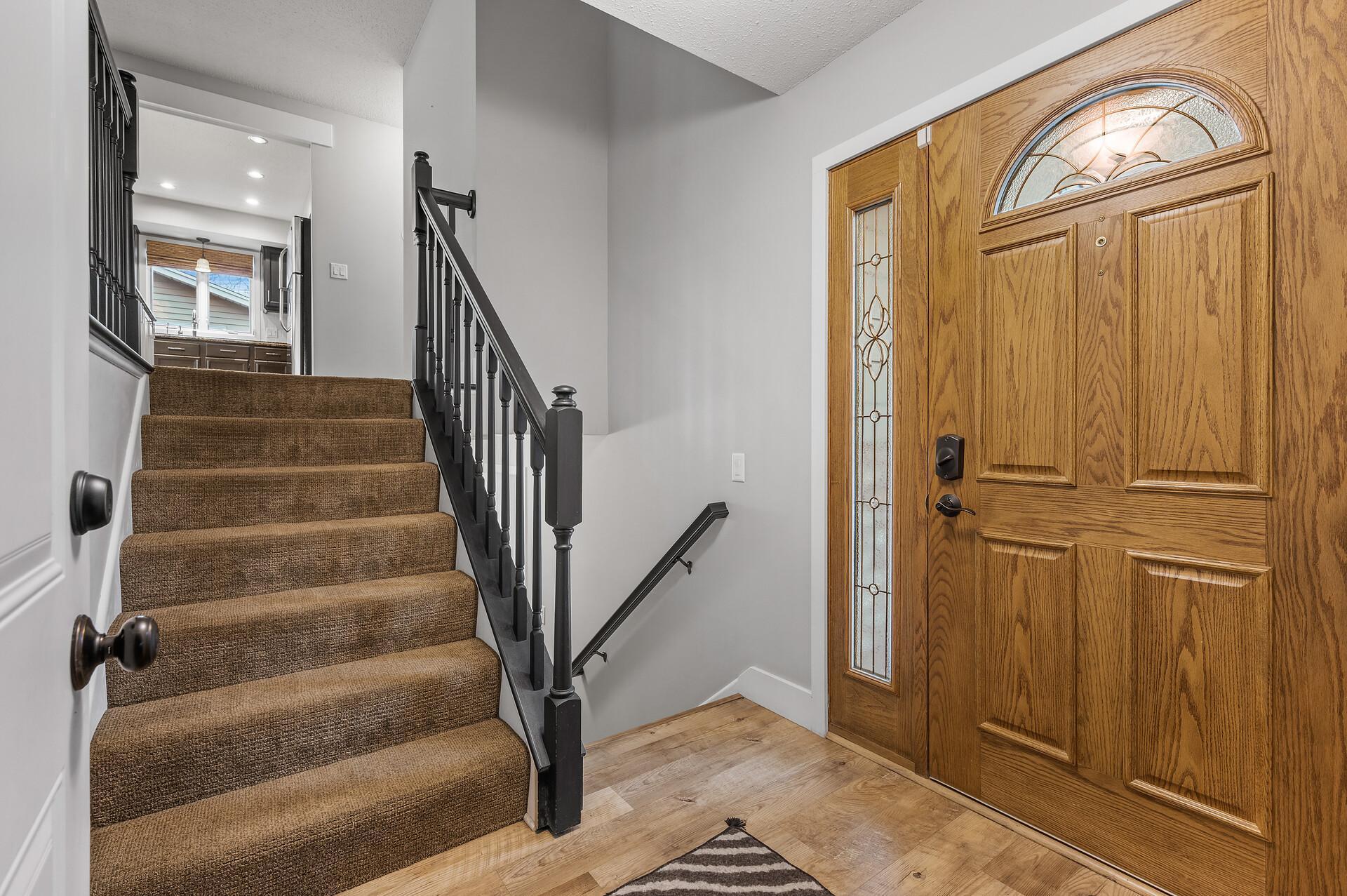 Step into a spacious foyer featuring durable engineered wood flooring, offering both style and room to move comfortably.
