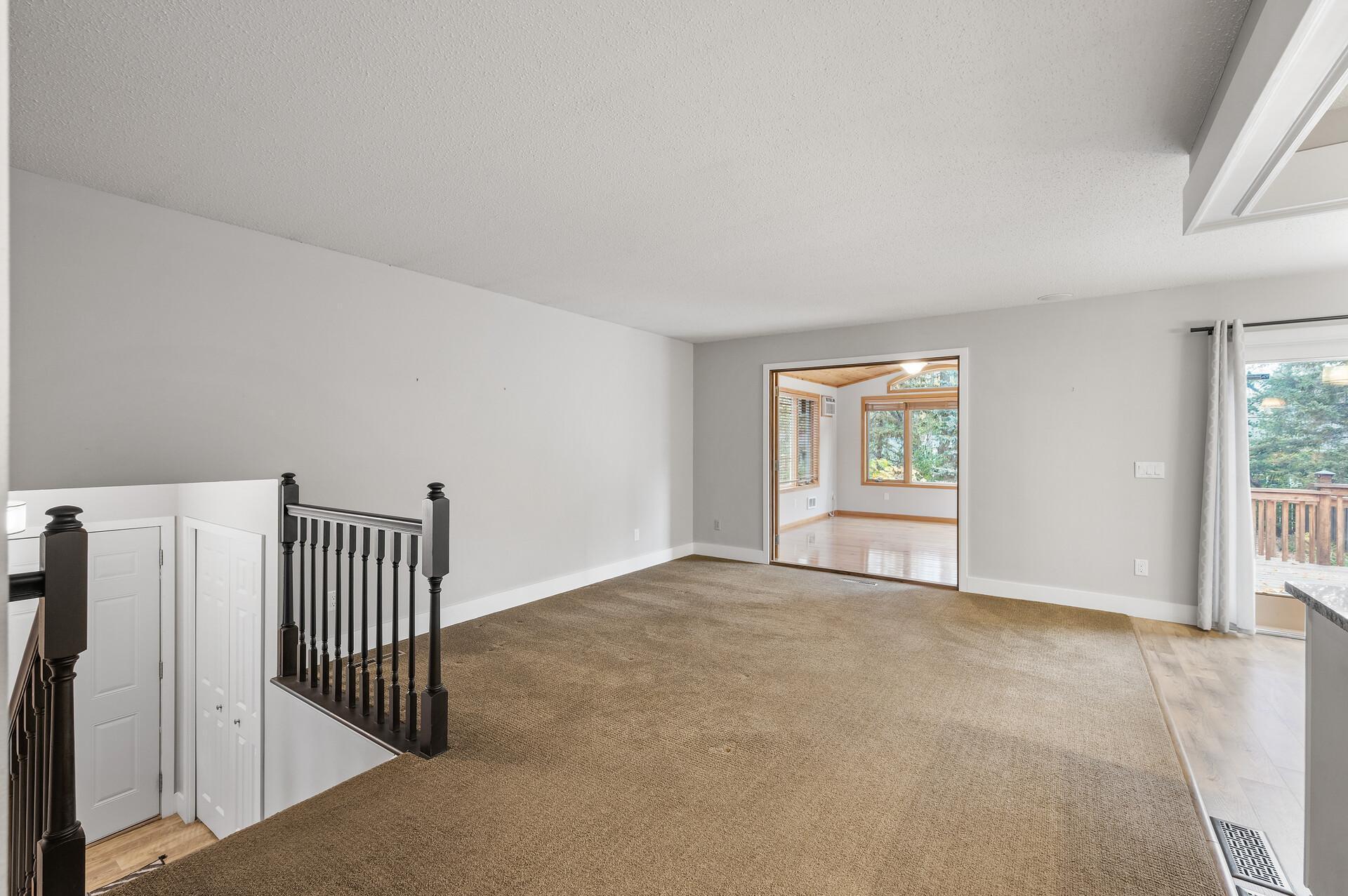 The inviting living room, offers ample space and a welcoming atmosphere that’s perfect for relaxing or entertaining.