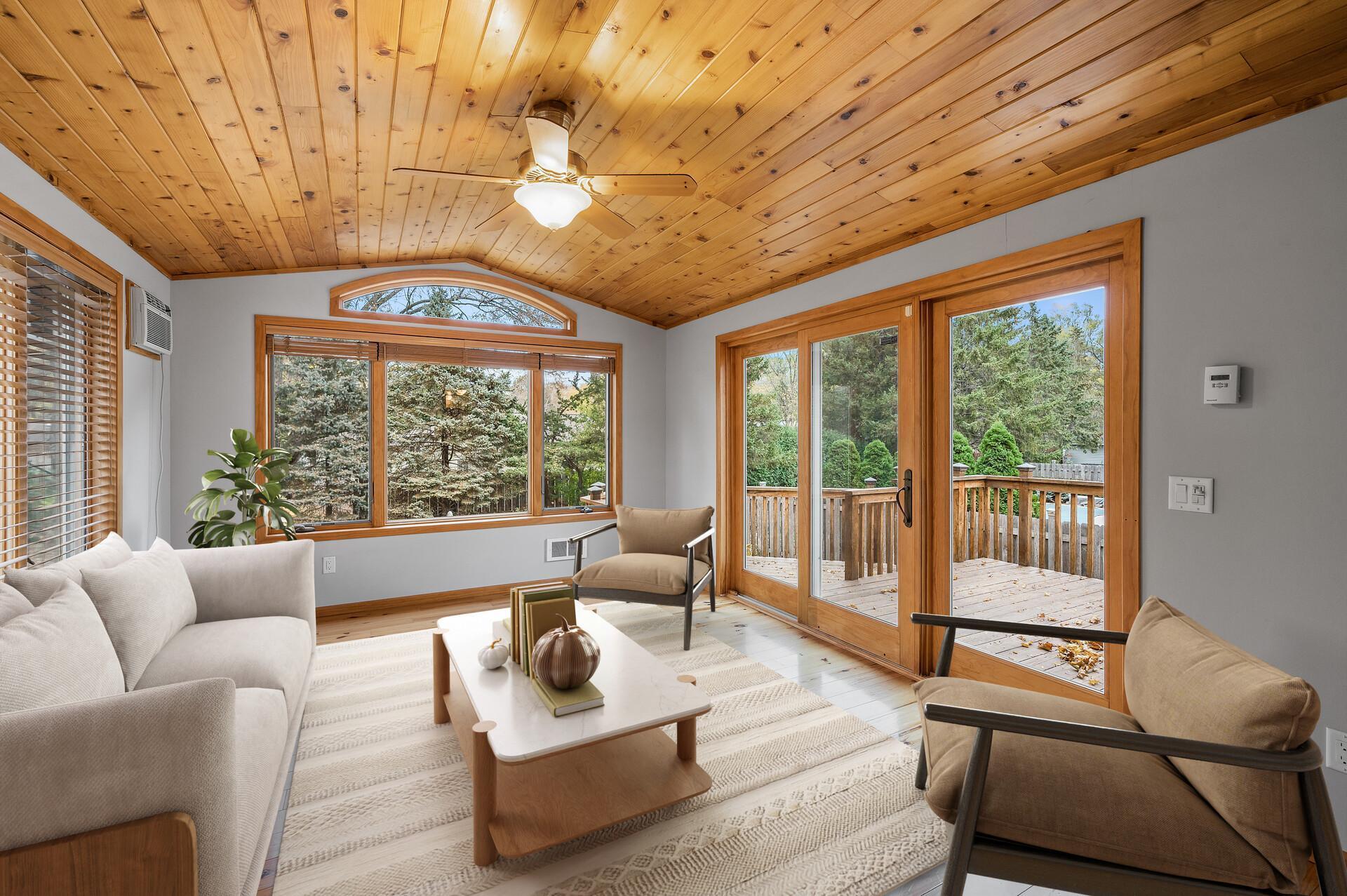 The stunning four-season porch features a beautiful cedar plank ceiling, durable laminate floors, and large windows that flood the space with natural light. With convenient deck access, this room is perfect for year-round enjoyment!