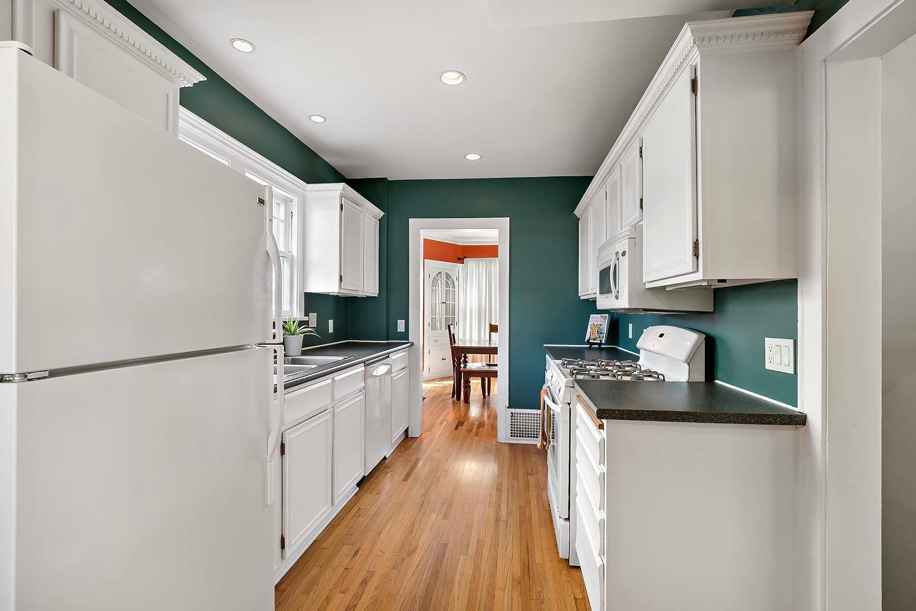 The spacious kitchen offers ample storage and a fresh, clean style.