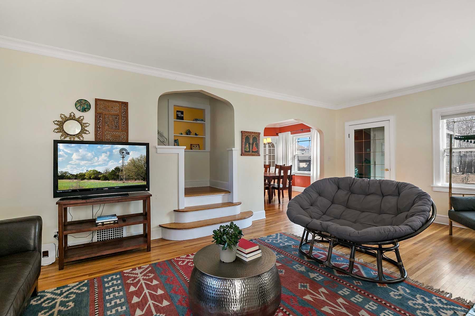 Visually appealing archways, built-in shelves and steps cascading into the living room.