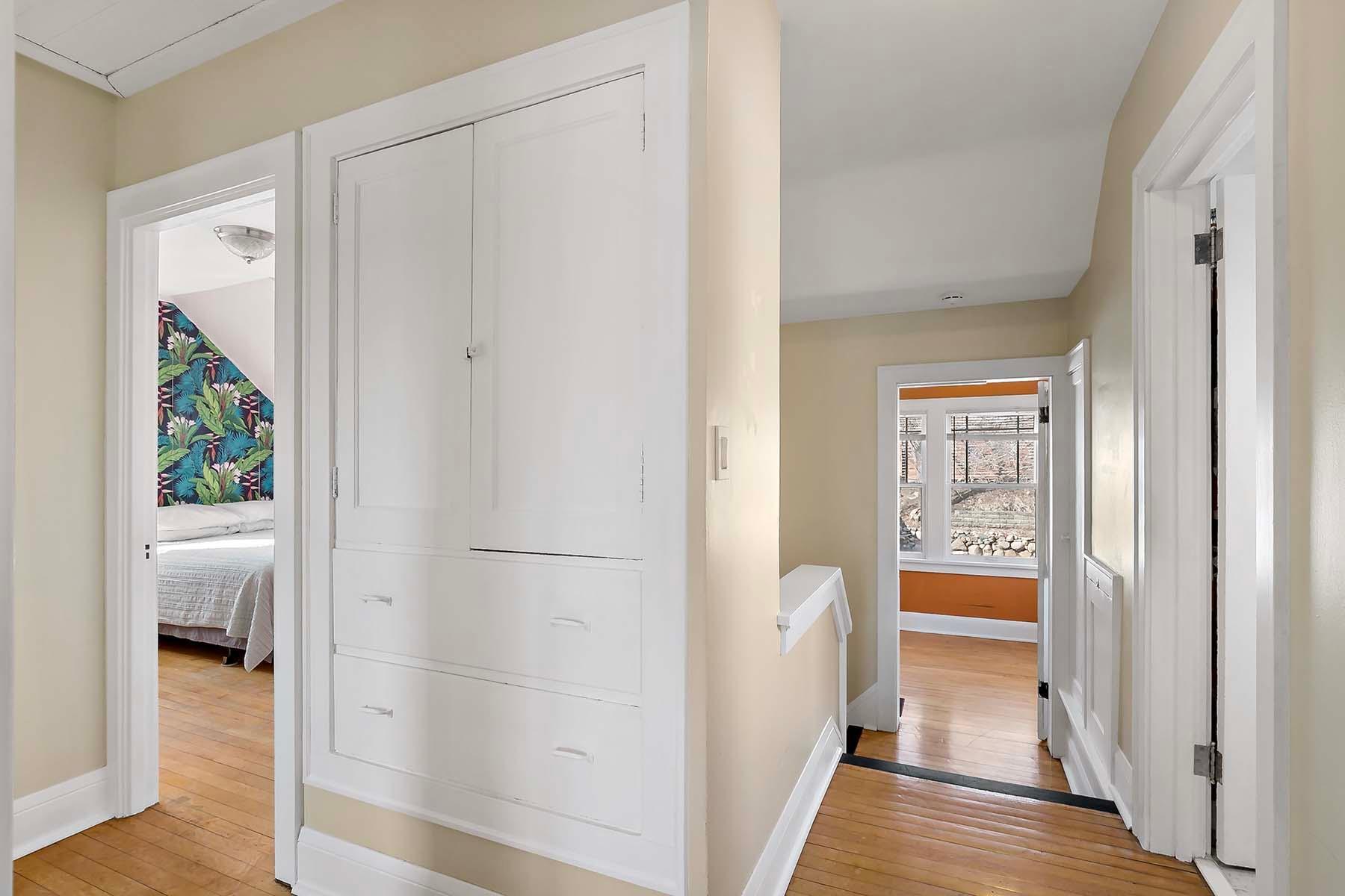 The built-in storage provides dedicated spaces for linens, towels, and other household items.
