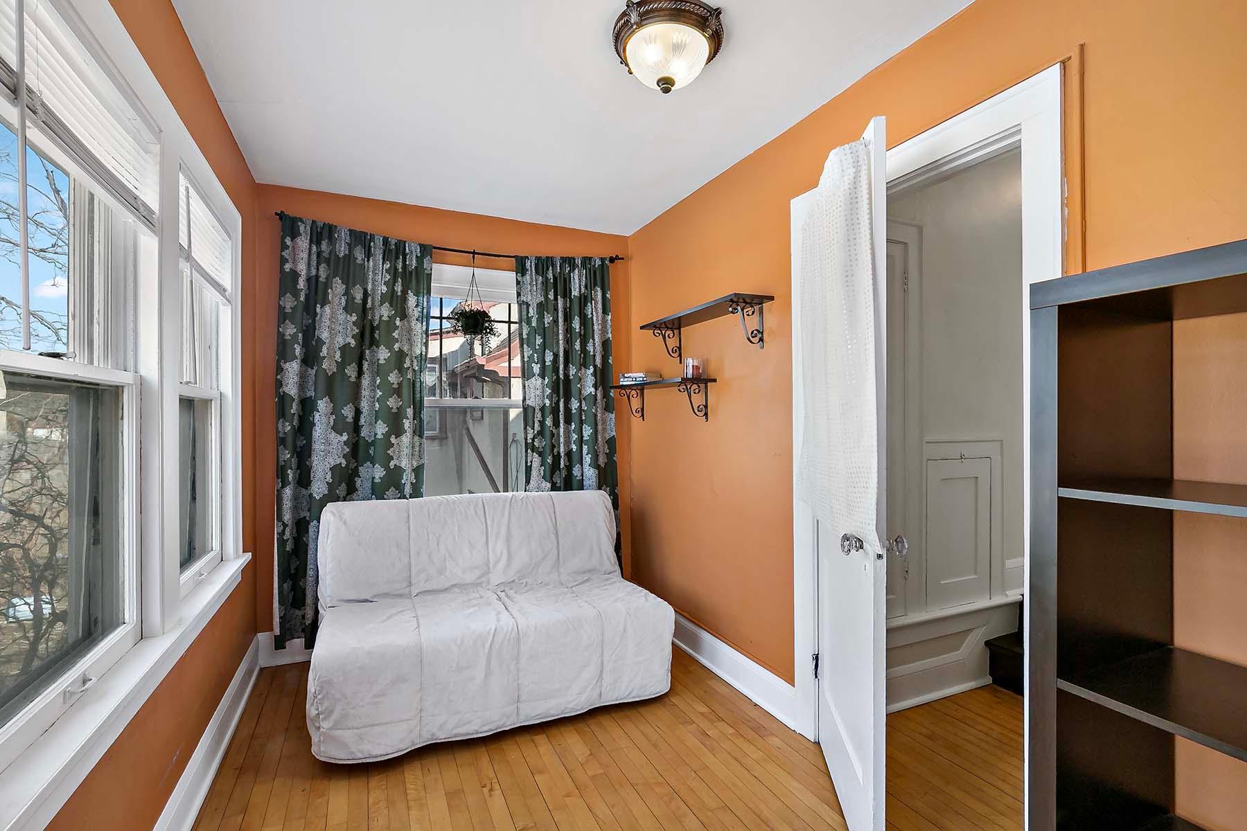 You'll find this cheerful sunroom at the top of the stairs and overlooking the backyard.