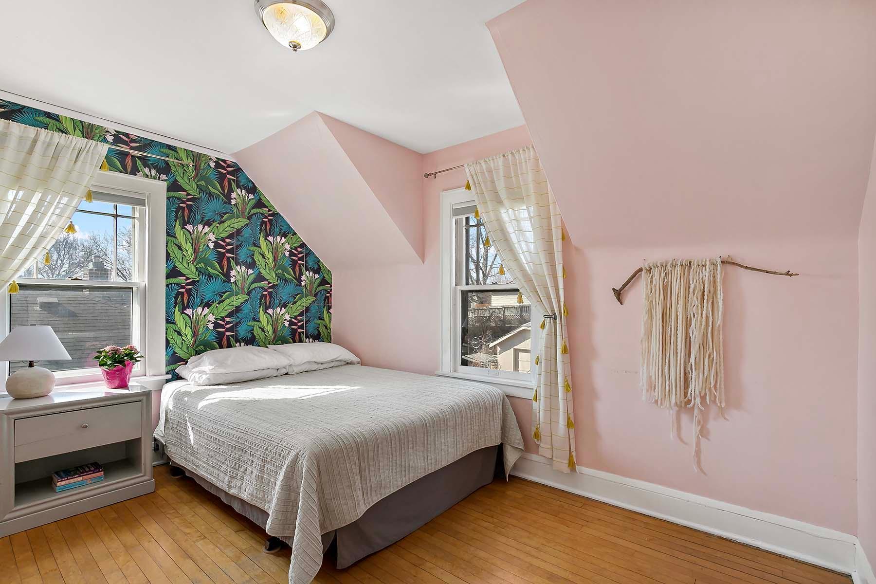 Bedroom number three in subtle pink and complementary dynamic wallpaper.