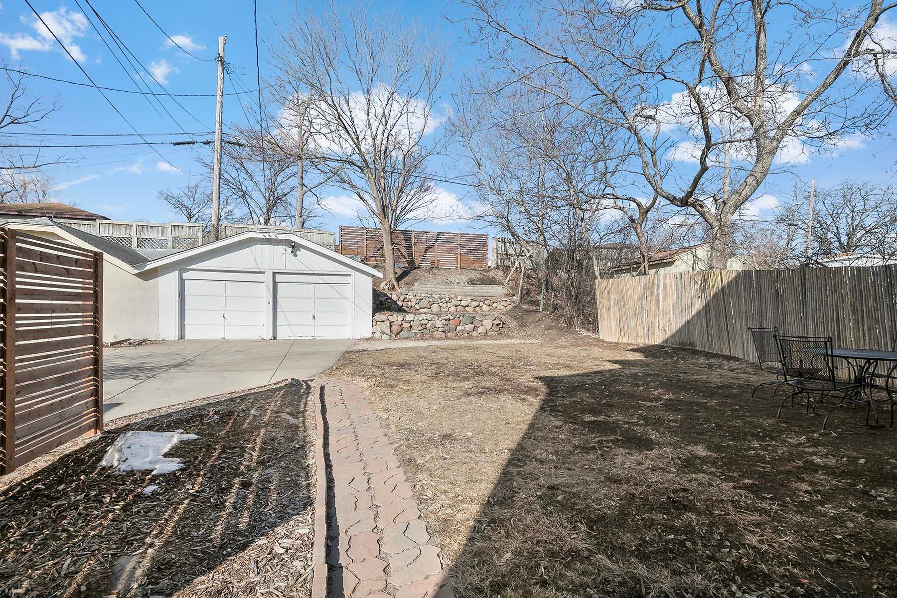 View of backyard with 2-car garage.