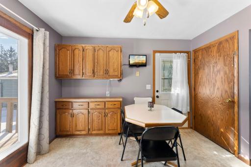 Adjacent to the kitchen is a cozy dining area that opens up to a lovely deck, perfect for outdoor dining or relaxing.
