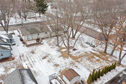 The large, flat backyard is perfect for outdoor activities, gardening, or simply unwinding, and it includes a storage shed for all your tools and equipment.