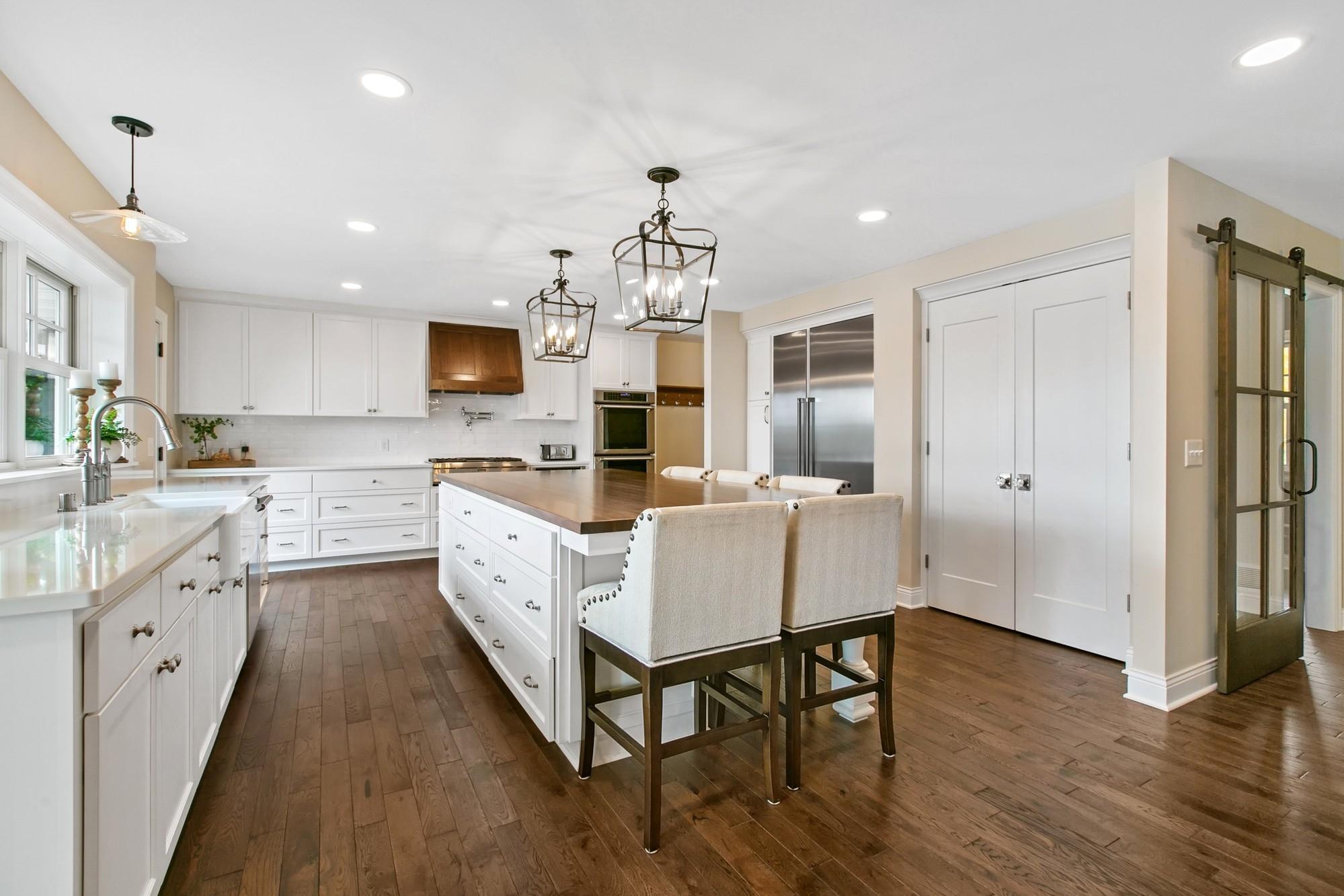 Silestone countertops, subway tiled backsplash, an abundance of white cabinetry, top of the line
Thermodor stainless steel appliances, two pantries and a pot filler above the stove.