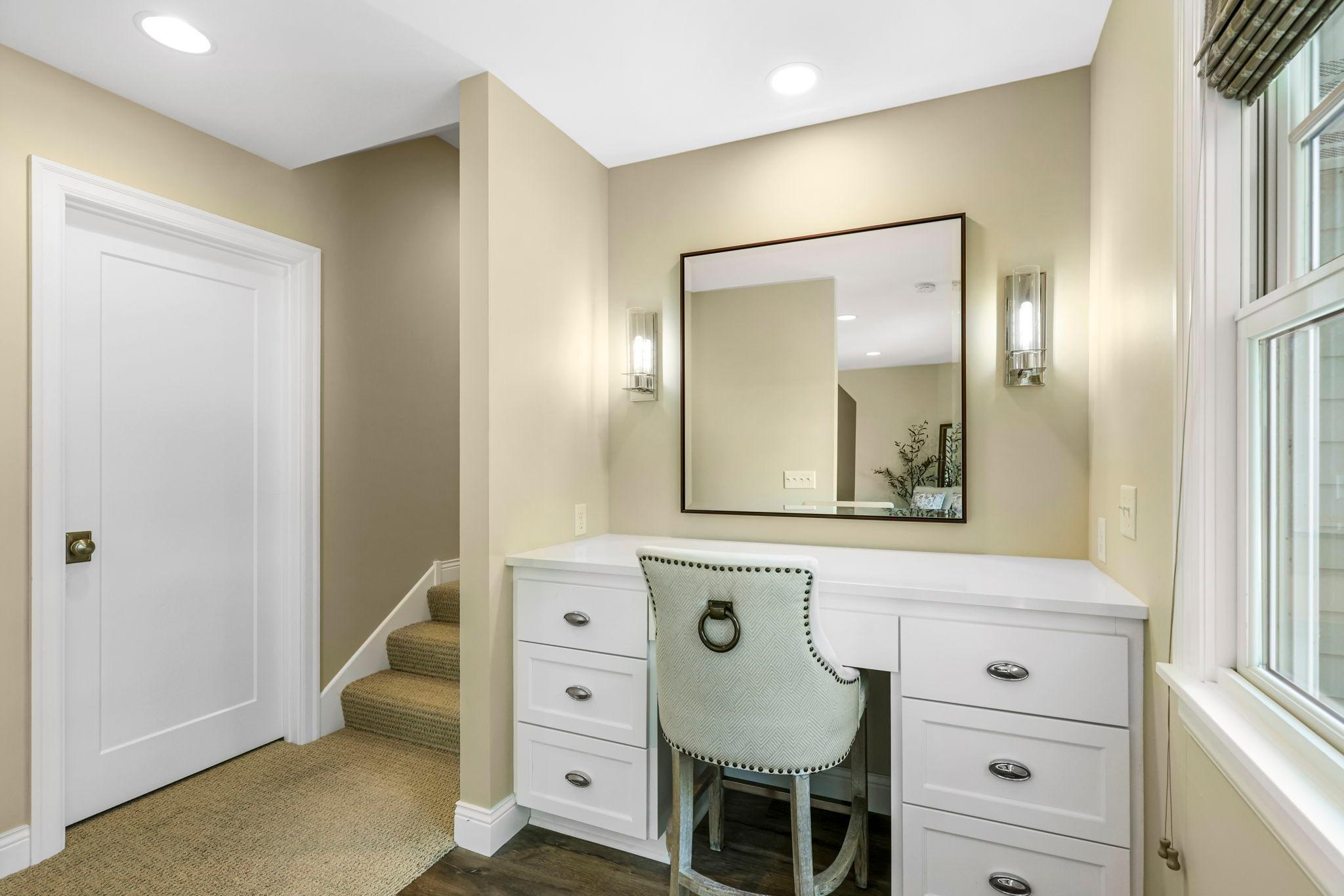 Cute makeup vanity attached to the primary bedroom. Door to the left is a large linen closet.
