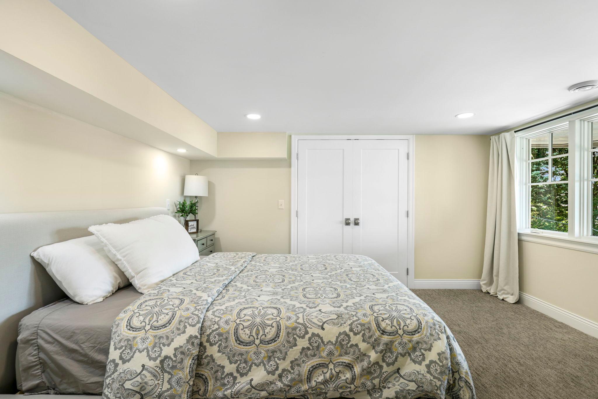 The fourth bedroom is in the lower level. The doors lead to the closet and an additional 17x16 climate-controlled storage room. The lower level makes for a perfect guest suite and is set up nicely for multi-generational living.