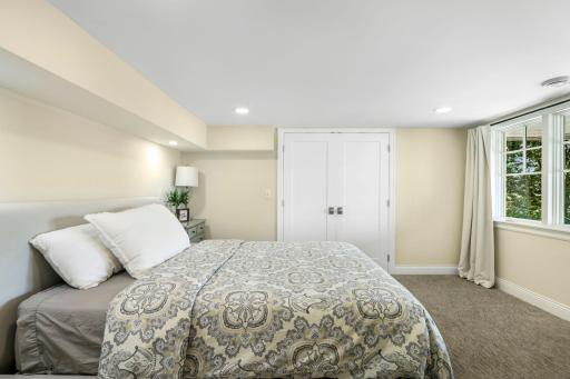 The fourth bedroom is in the lower level. The doors lead to the closet and an additional 17x16 climate-controlled storage room. The lower level makes for a perfect guest suite and is set up nicely for multi-generational living.
