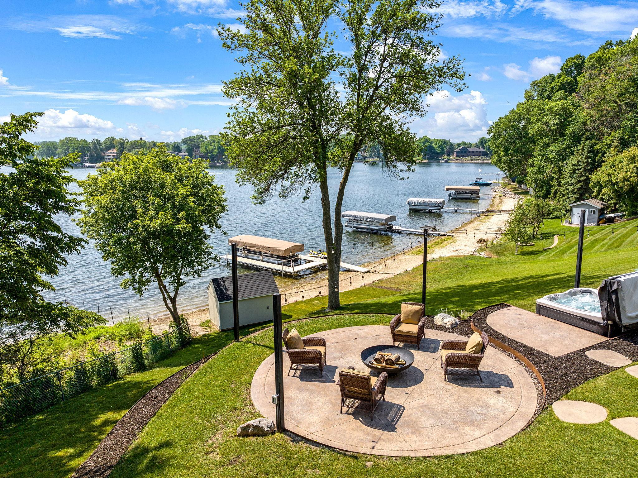 Stone pavers lead from the back of the home to the stamped firepit patio and built-in hot tub.