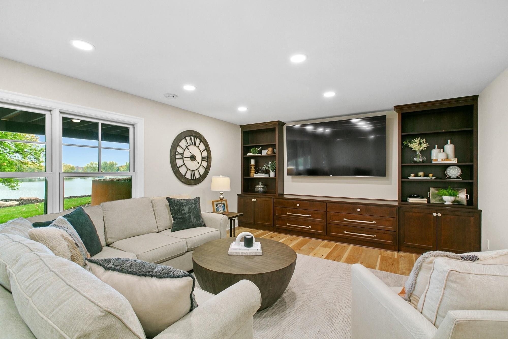 Big family room with generous sized built-in shelving. Great space to watch those football games!