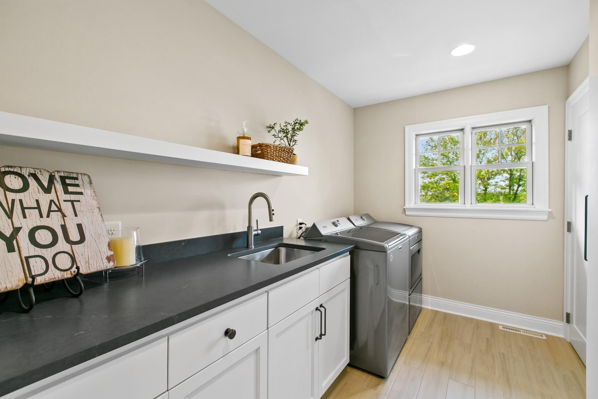 Upper-level laundry boasts ample storage and a sizeable storage closet.