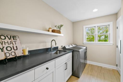 Upper-level laundry boasts ample storage and a sizeable storage closet.