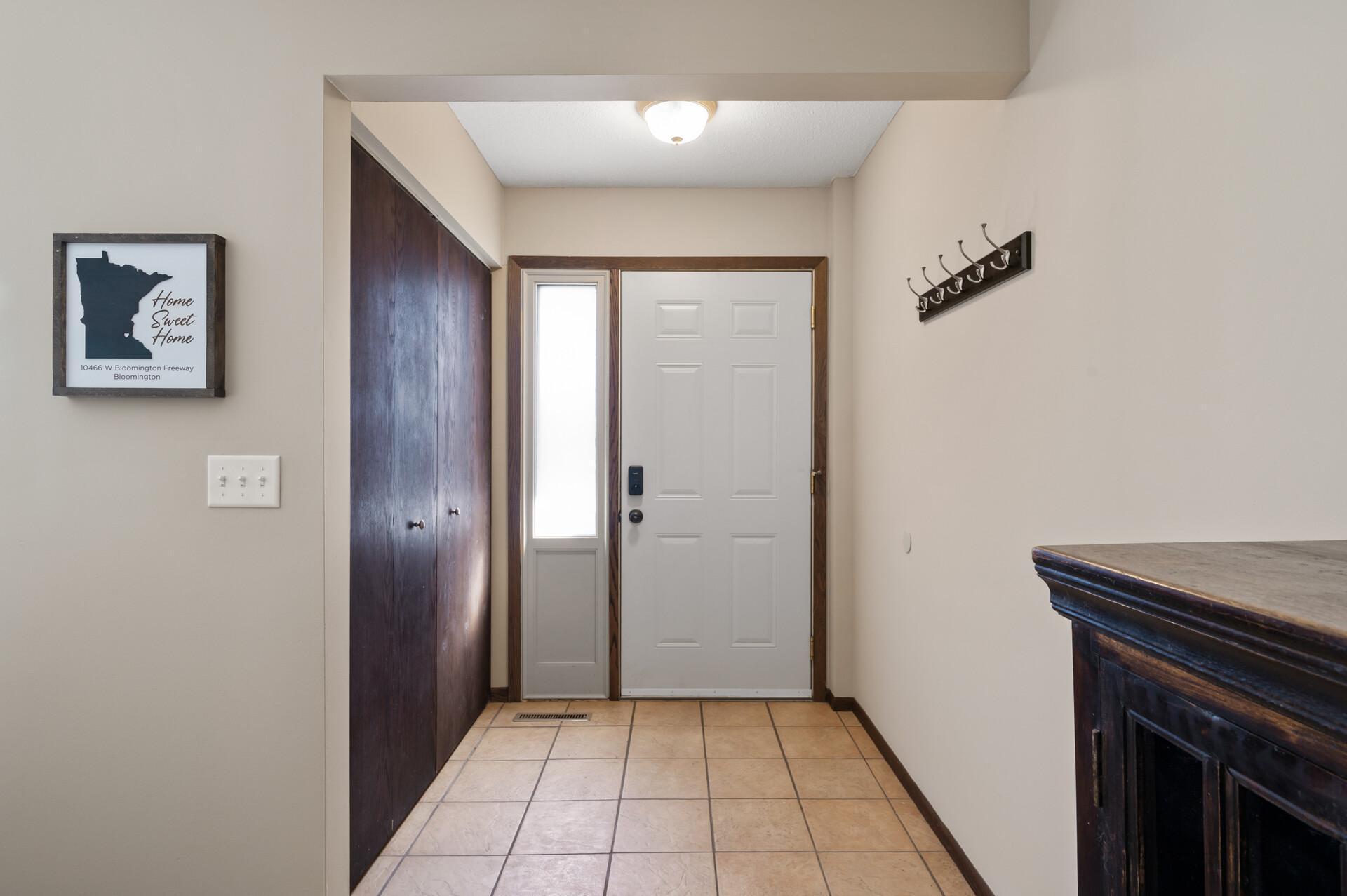 A closer look at the foyer shows a nice coat closet for all of your outerwear, shoes, and bags. The sidelight window provides extra light in the space.