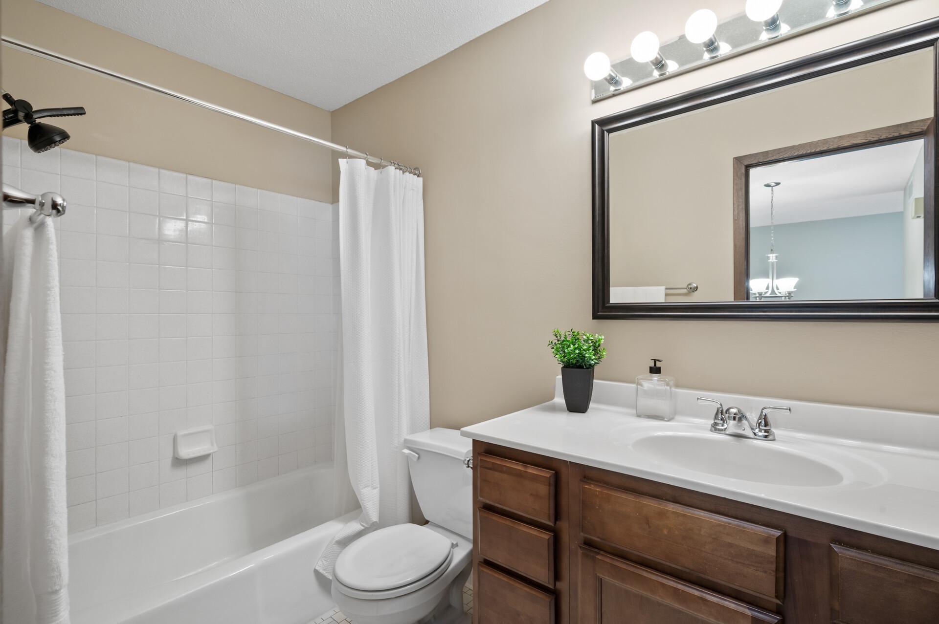 There is a full bathroom on the third level that includes an oversized vanity, a tub/shower combo with an updated oil rubbed bronze showerhead, and just out of view is an enormous built-in cabinet sure to fit all your bathroom essentials.
