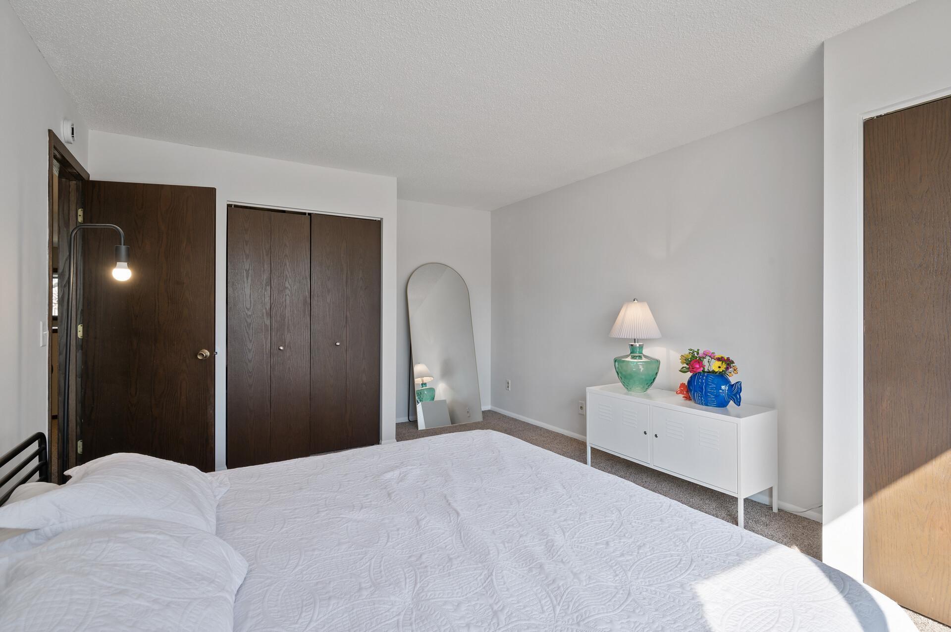 This reverse view shows the second closet and the inset nook in the corner of the room perfect for a desk or dresser.