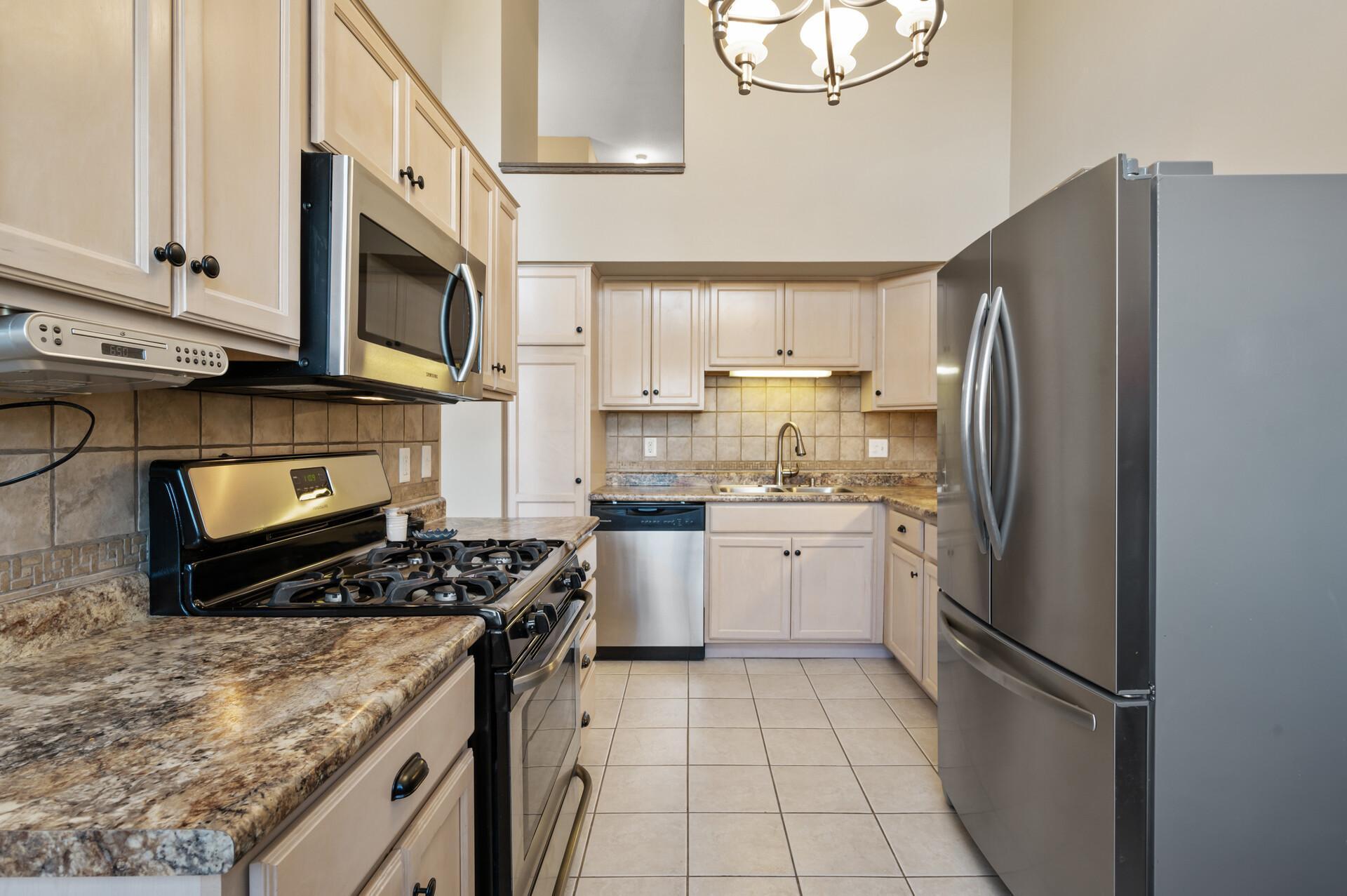 In this alternate view of the kitchen you can see the opening on the far end that looks through to the third level.