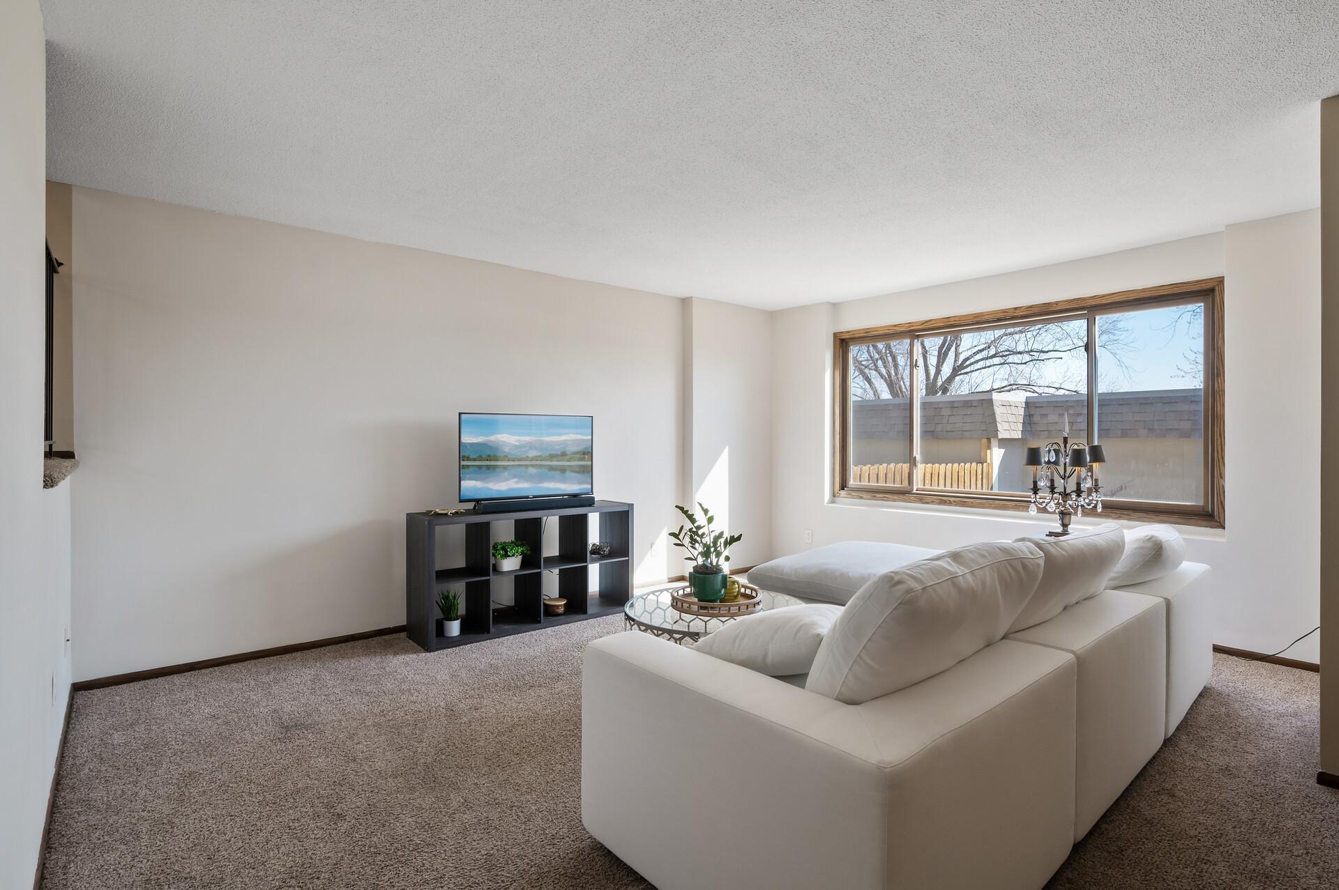 The main level living room was freshly painted in March 2025 and offers an amazing window for natural light.