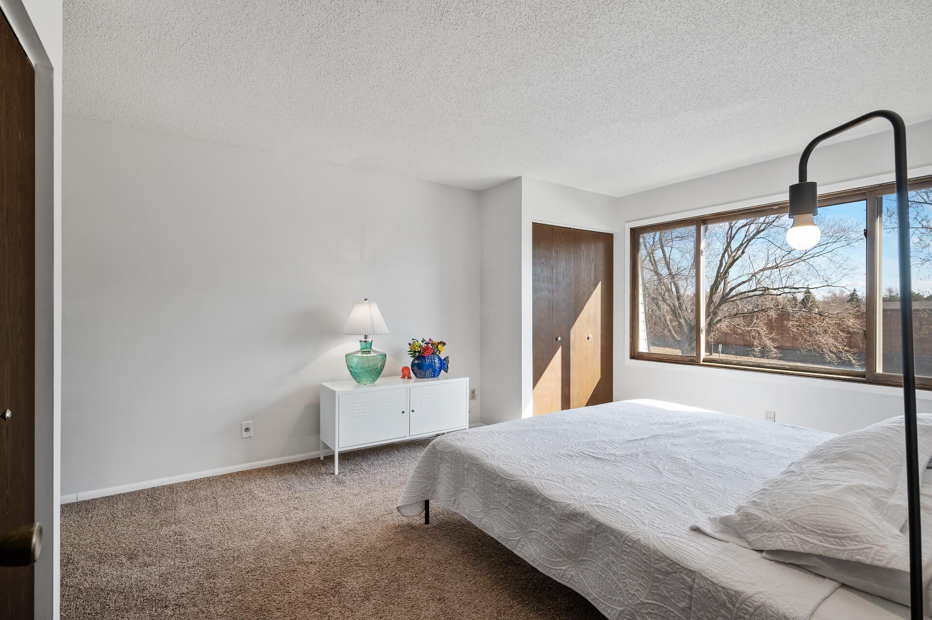 In this alternate view of the primary bedroom you can see one of the two closets.