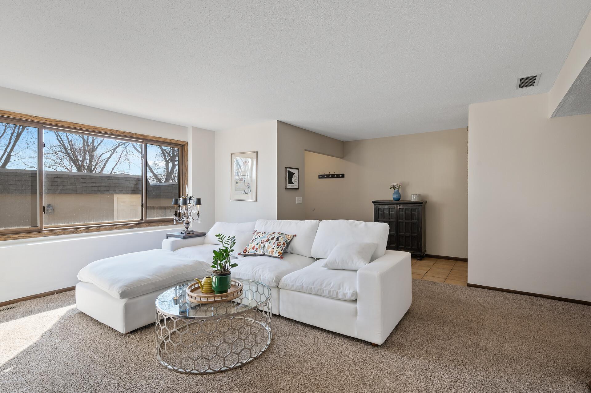 The living room is spacious and will easily fit the furniture of your choice.