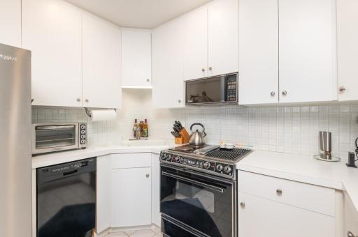 Plenty of cabinetry and counter space to prepare a meal after a day of boating and clean ceramic tile back splash.